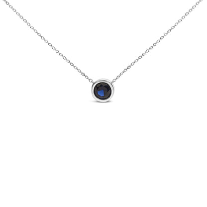 White necklace with a round blue gemstone in bezel setting, shown from the front on a white background.