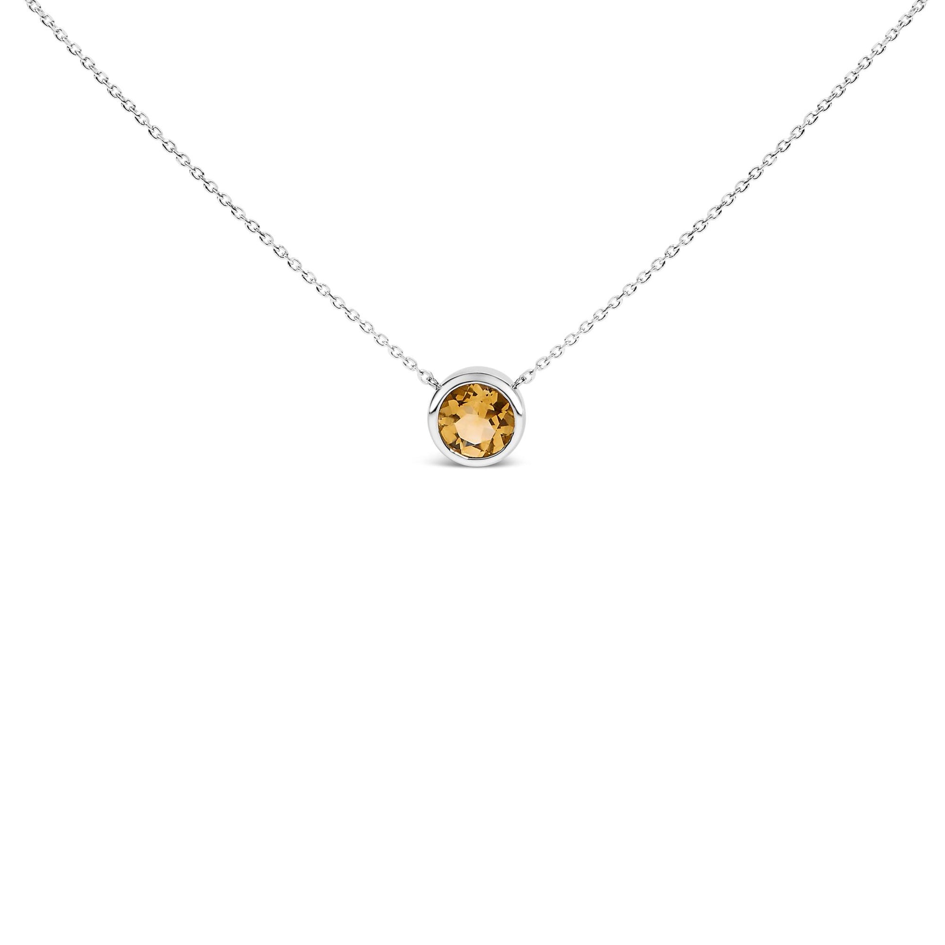 White necklace with a round yellow gemstone in a bezel setting, shown in a front-facing close-up.