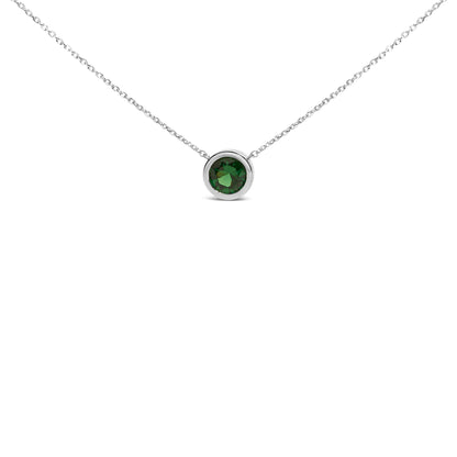 Close-up front view of a white necklace with a single round green gemstone in a bezel setting.