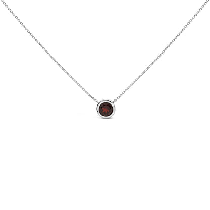 Front view of a white necklace with a round red gemstone set in a bezel setting on a chain, isolated on white background.