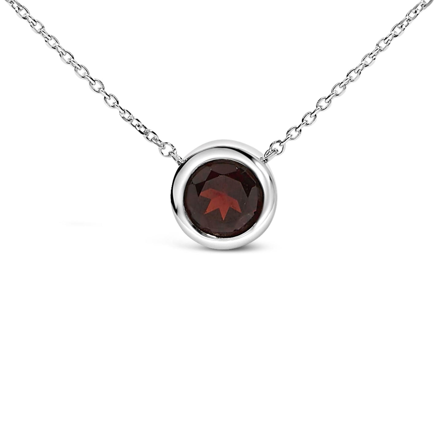 Close-up front angle of a white metal necklace with a round red gemstone in a bezel setting.