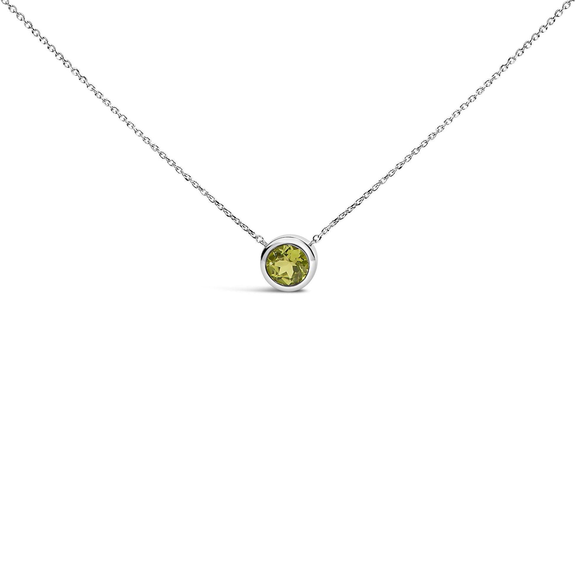 White necklace with a round green gemstone in a bezel setting, shown in a front-facing close-up shot.