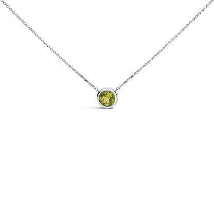 White necklace with a round green gemstone in a bezel setting, shown in a front-facing close-up shot.