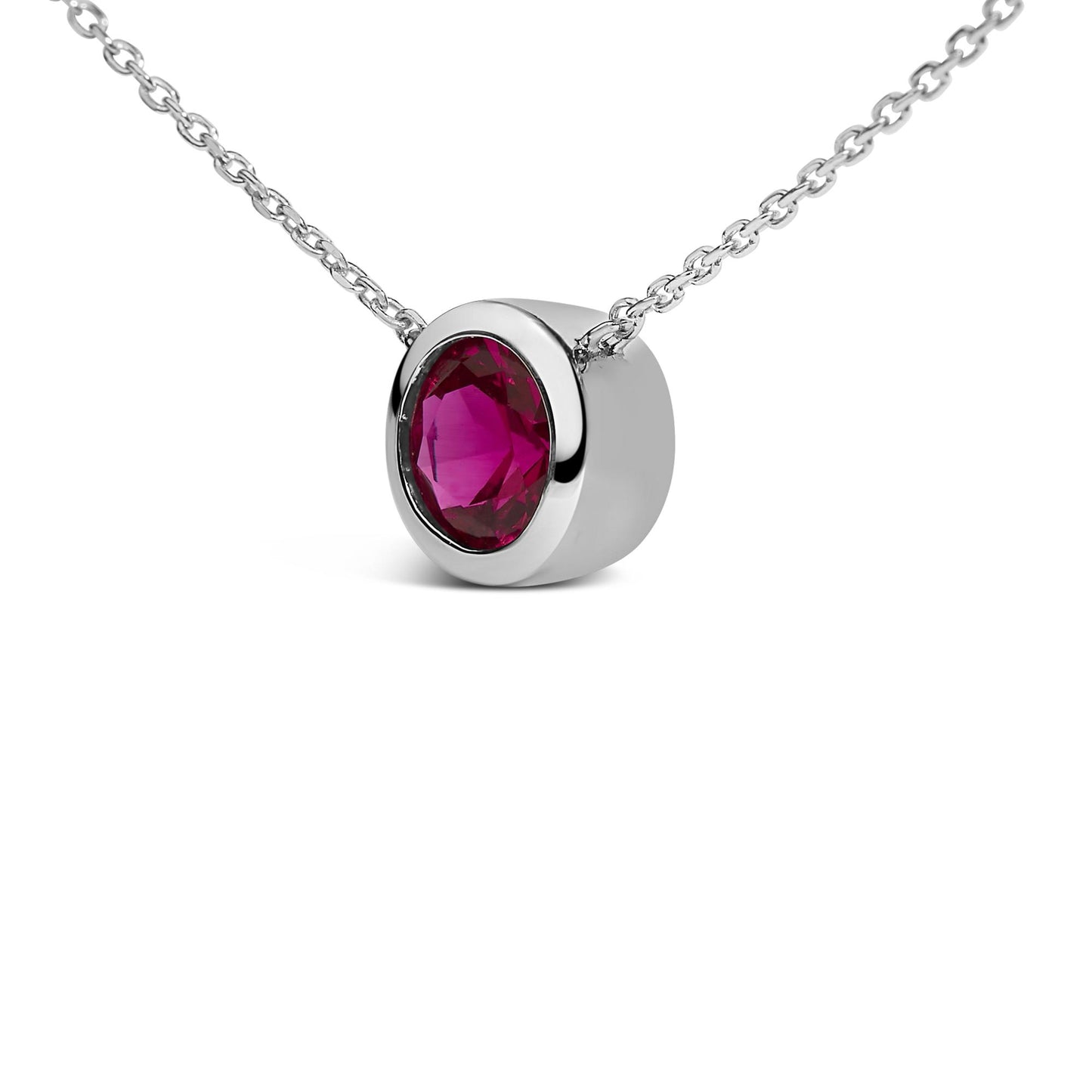 Close-up front angle of a white metal necklace with a round red gemstone in a bezel setting.