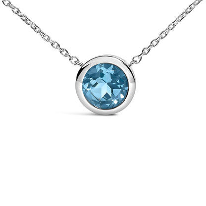 Close-up front view of a white metal necklace featuring a round, blue gemstone in a bezel setting at the center.