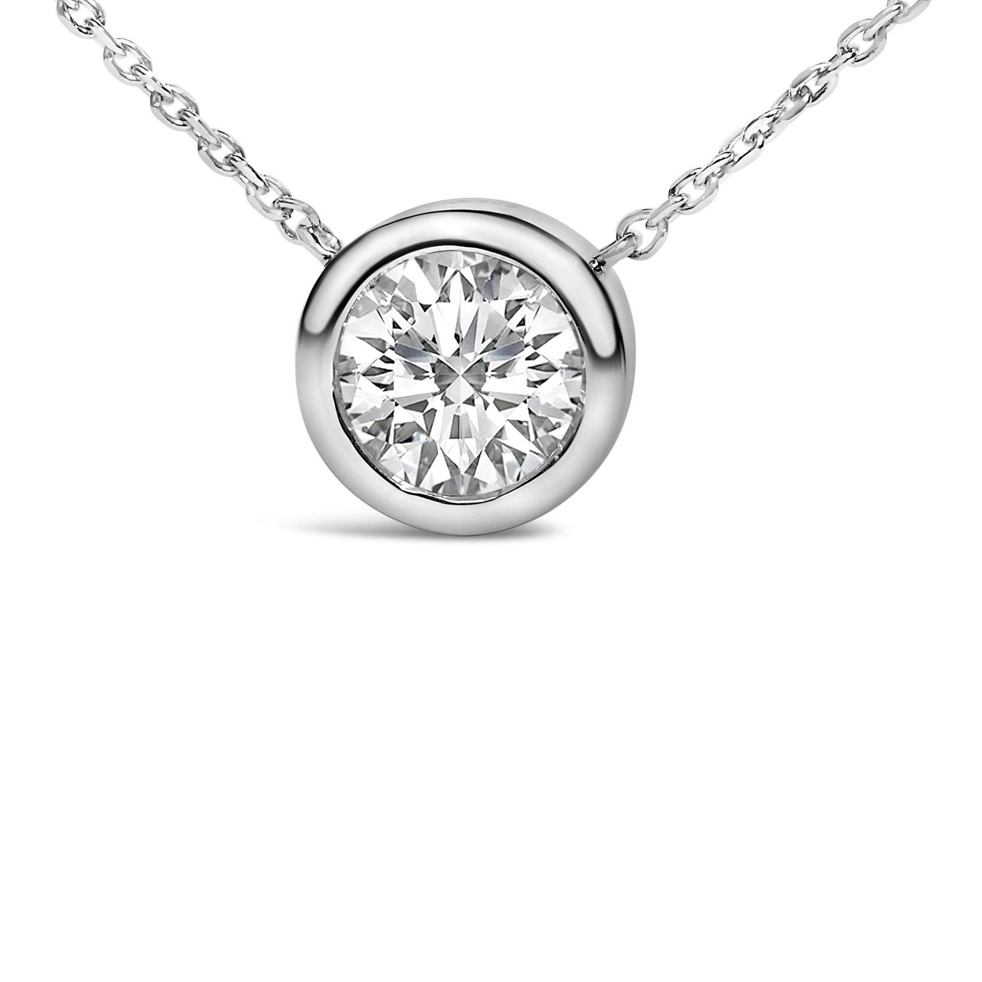 Close-up front view of a white metal necklace with a round white gemstone in a bezel setting.