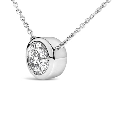 Close-up angled view of a white metal necklace with a round white gemstone in a bezel setting.