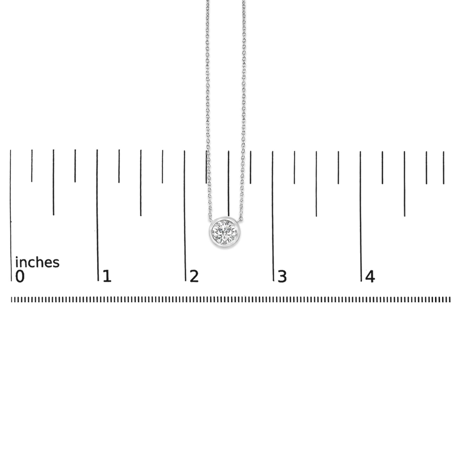 White necklace with a single round white gemstone in bezel setting, shown hanging vertically in front of a ruler for scale, front view.