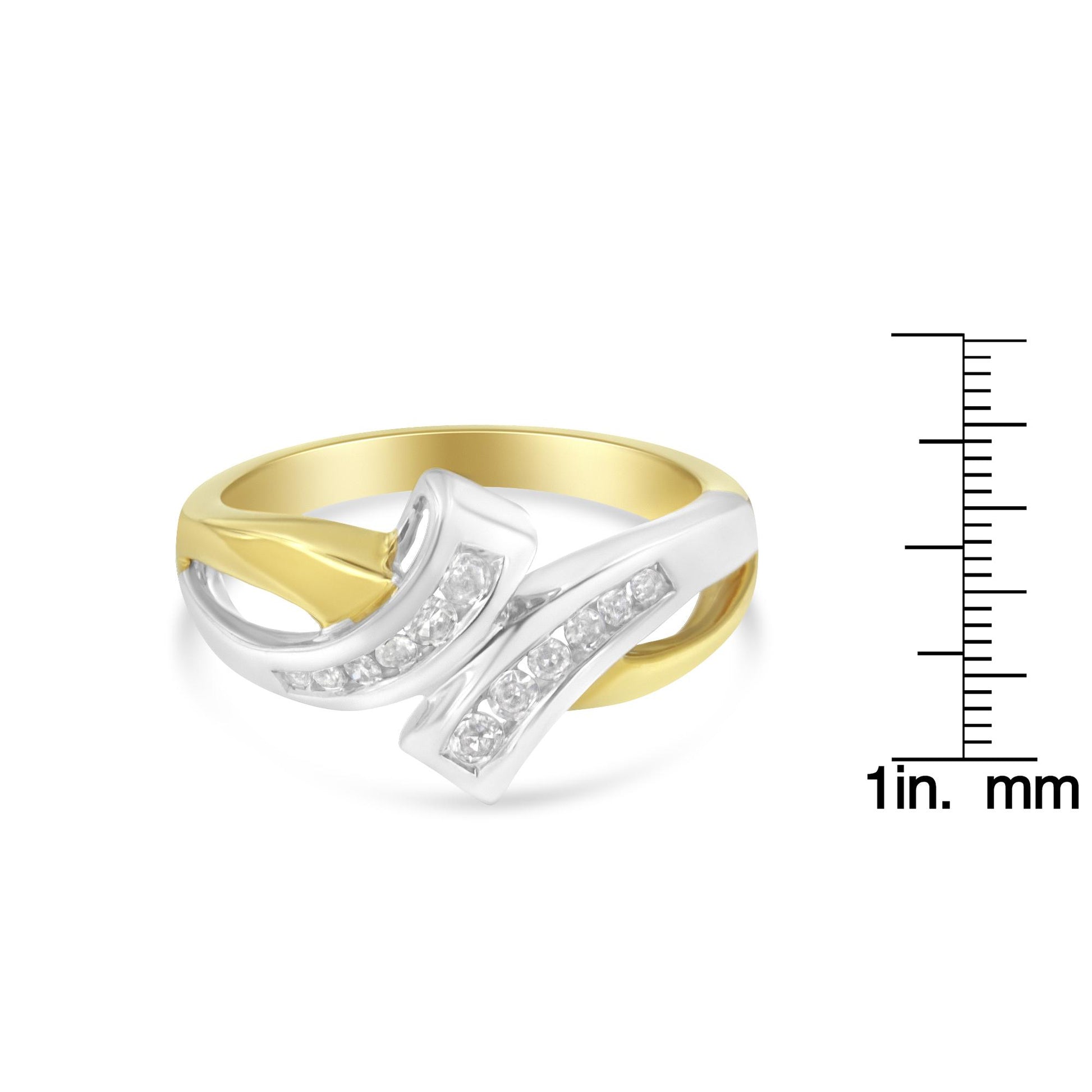 Two-toned ring with a curved design featuring channel-set round white gemstones, shown from a front angle, placed next to a ruler for size reference.