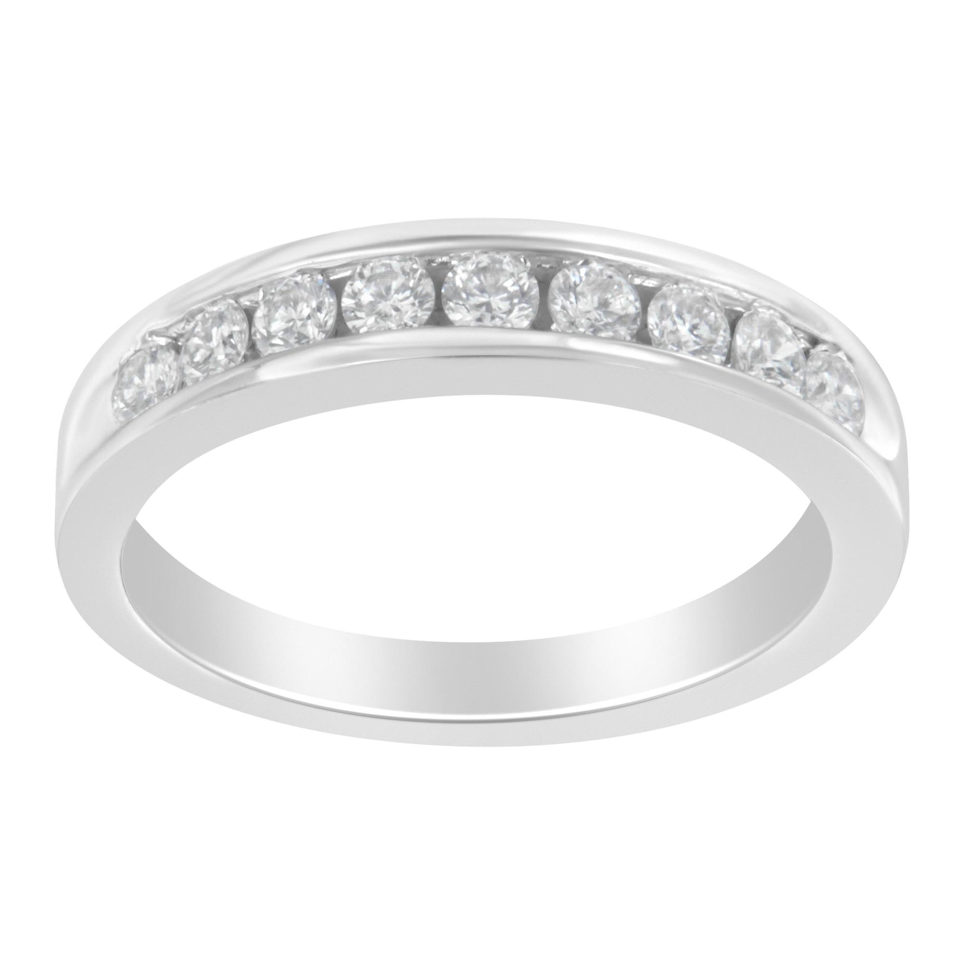 White metal ring with round white gemstones set in a channel, shown at a slight angle.