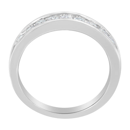 Top-down view of a white ring with a channel setting featuring round white gemstones encircling part of the band.