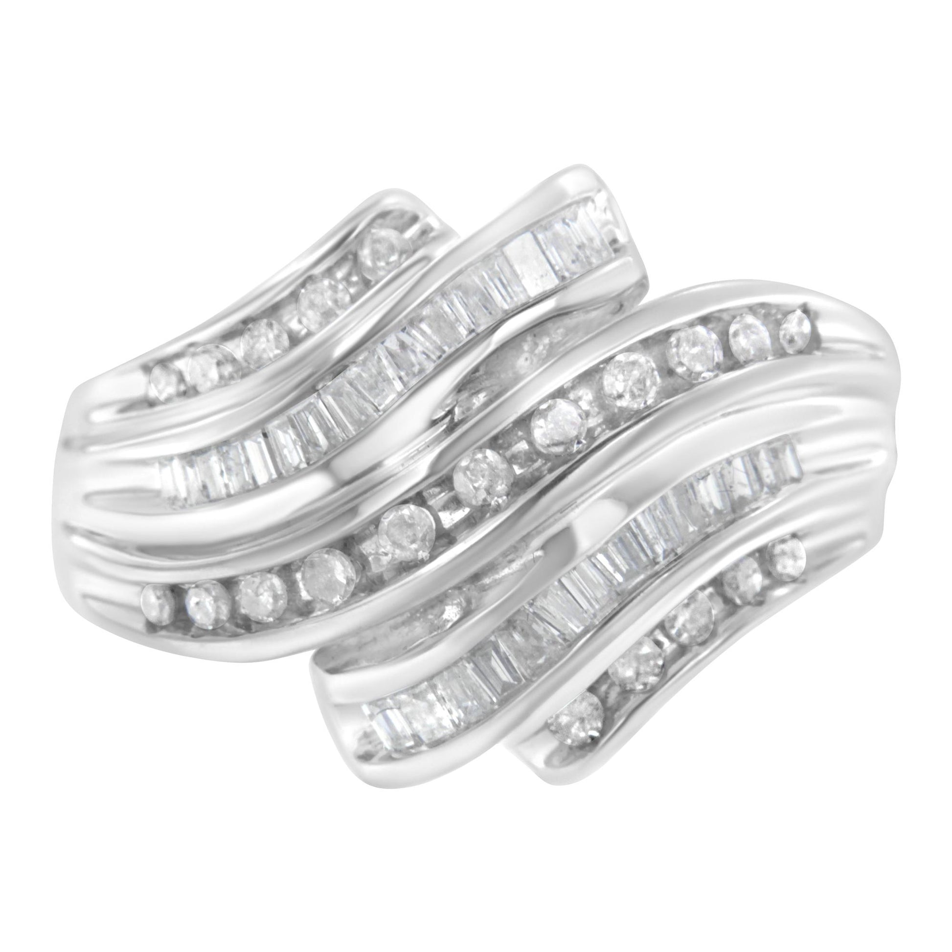 White metal ring shown from a top angle featuring alternating rows of round and baguette white gemstones in a channel setting.