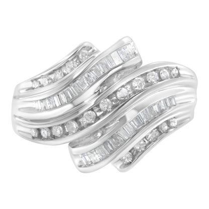 White metal ring shown from a top angle featuring alternating rows of round and baguette white gemstones in a channel setting.