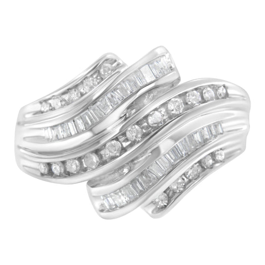 White metal ring shown from a top angle featuring alternating rows of round and baguette white gemstones in a channel setting.