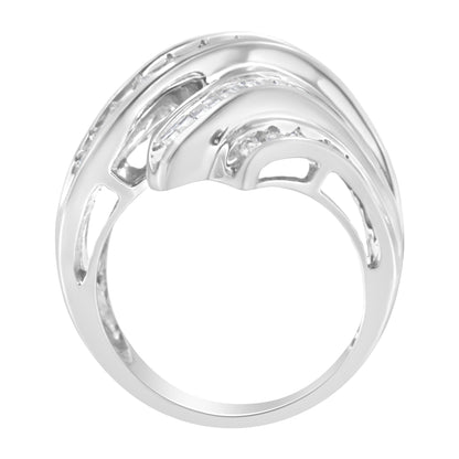 Top-front angle view of a white metal ring featuring channel-set white round and baguette gemstones arranged in a layered design.