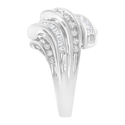 Close-up front view of a white metal ring featuring channel-set round and baguette-shaped white gemstones arranged in flowing, curved bands.