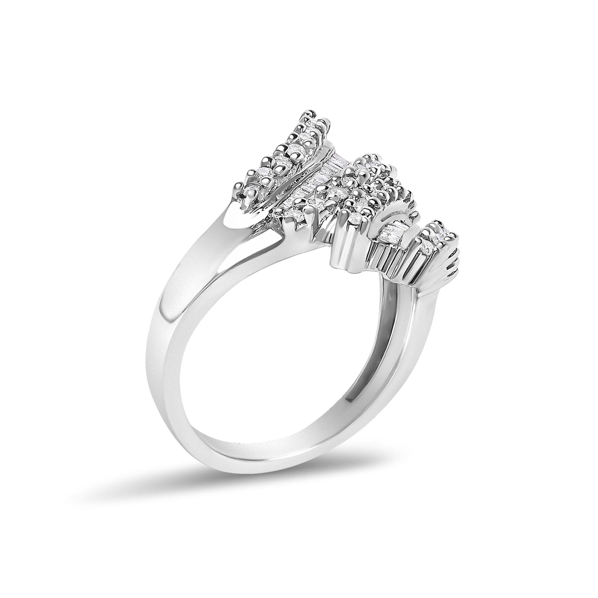 White metal ring shown at an angled side view with clusters of round white gemstones in prong settings and baguette white gemstones in channel settings on the top.