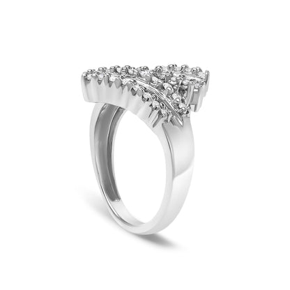 White metal ring with a wide band shown at a three-quarter angle, featuring a triangular cluster of round prong-set white gemstones and a curved row of channel-set baguette white gemstones.