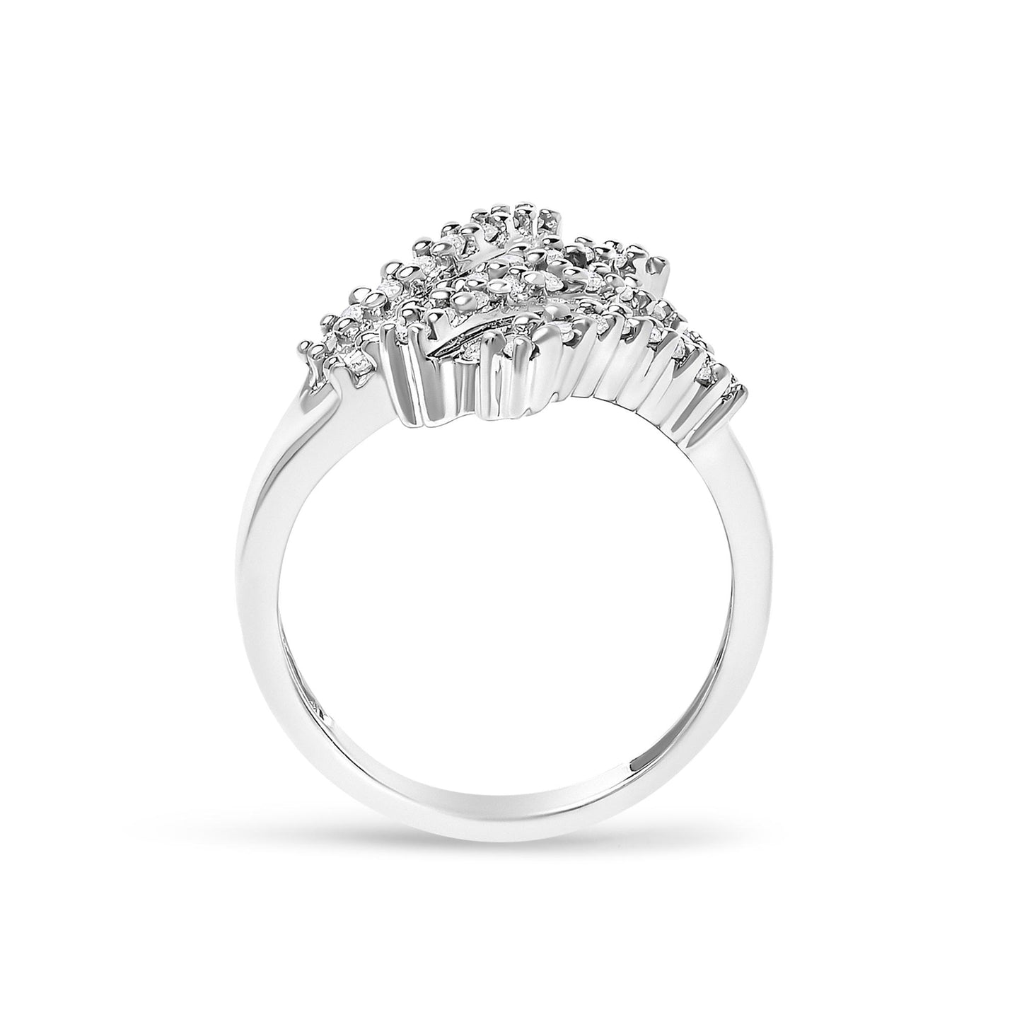 Close-up front view of a white metal ring featuring multiple round white gemstones in prong settings and baguette white gemstones in channel settings arranged decoratively across the top.
