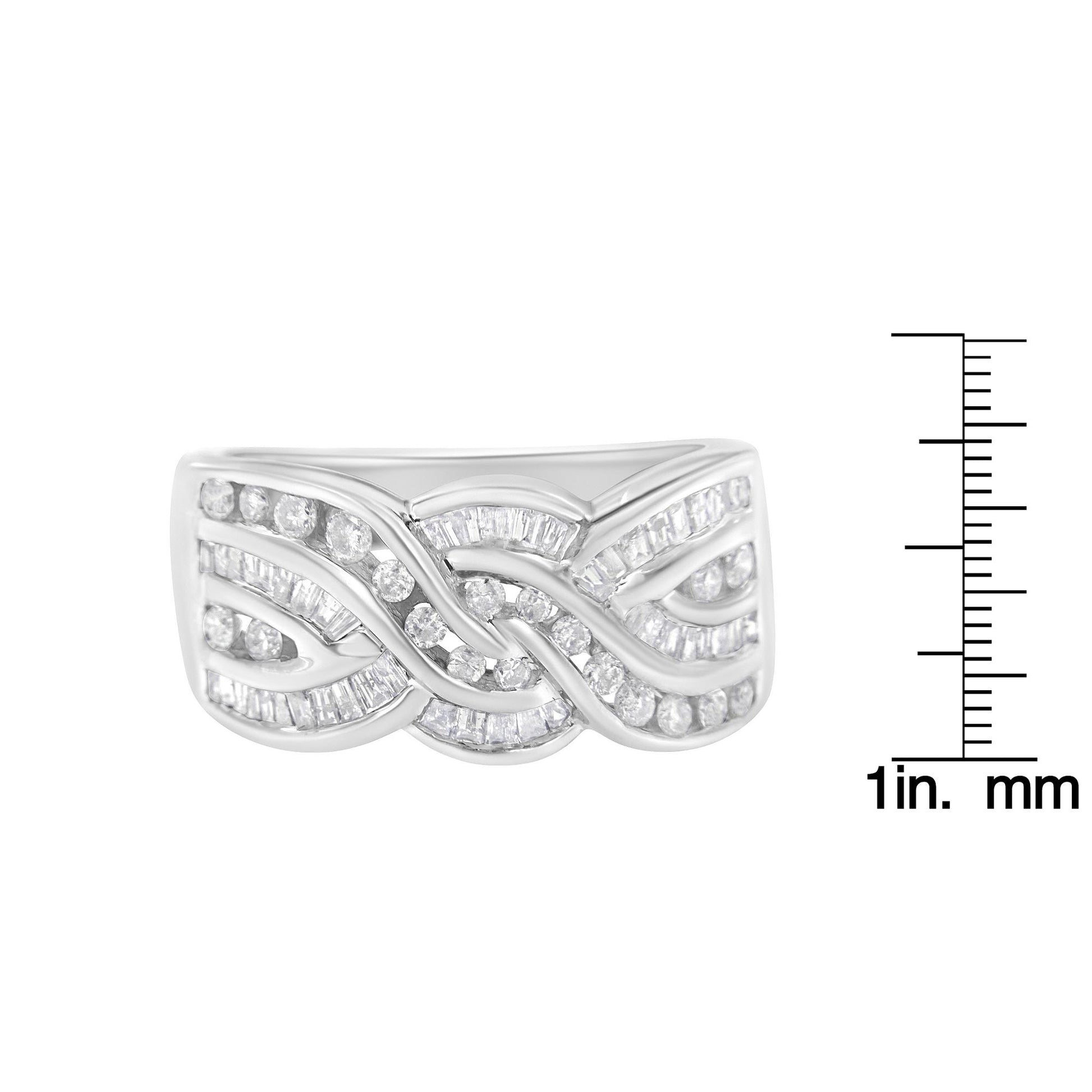 Front view of a white metal ring with an intricate wave pattern featuring round and baguette shape white gemstones in channel settings, shown next to a ruler for size reference.