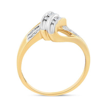 Two-toned ring with round white gemstones in channel settings, shown from side angle.