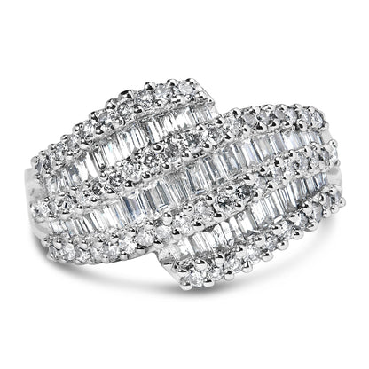 Close-up of a white metal ring with overlapping rows of channel-set baguette-shaped white gemstones and prong-set round white gemstones, shown from a front angle.