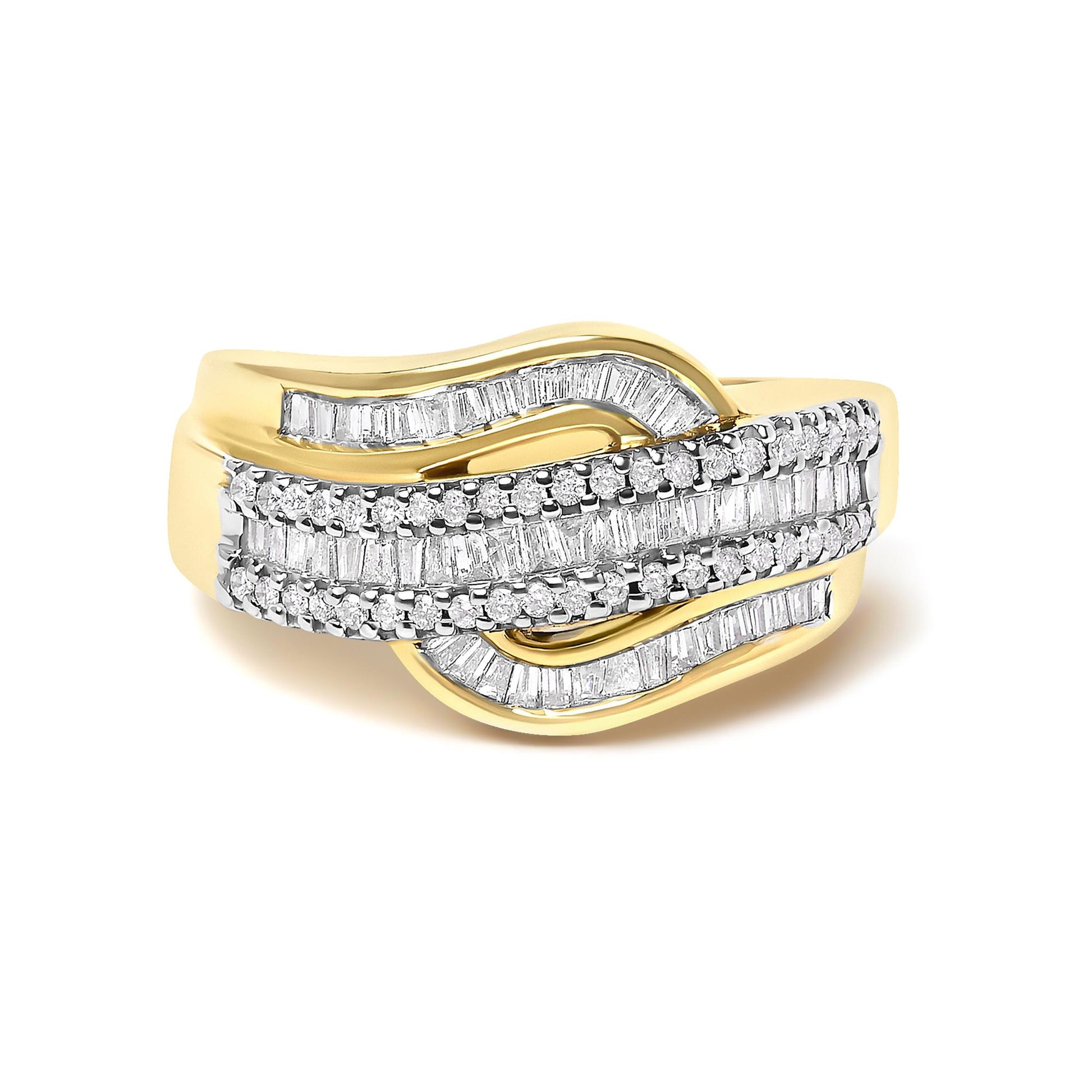 Yellow metal ring with an overlapping wave design, featuring rows of round white gemstones in prong settings and baguette white gemstones in channel settings, shown at a slight angle on a white background.
