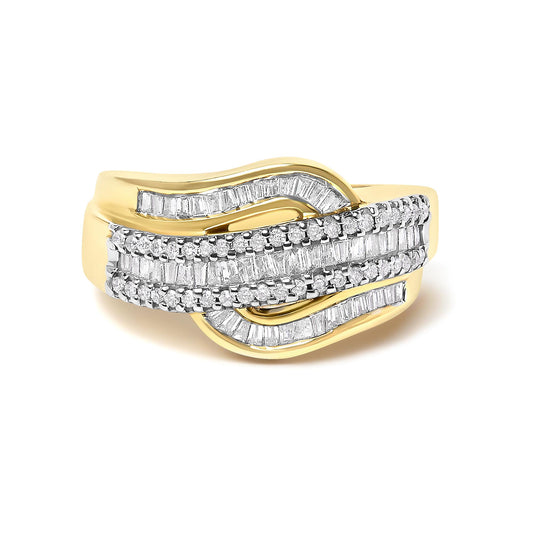 Yellow metal ring with an overlapping wave design, featuring rows of round white gemstones in prong settings and baguette white gemstones in channel settings, shown at a slight angle on a white background.