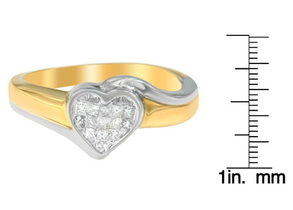 Ring with yellow and white metal featuring a heart-shaped cluster of princess-cut white gemstones in a channel setting, shown in a side angle with a ruler for size reference.