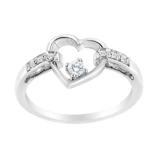 White metal ring with an open heart design, featuring a round white gemstone in a four-prong setting at the center and additional small white gemstones embedded on each side, shown from a front angle.