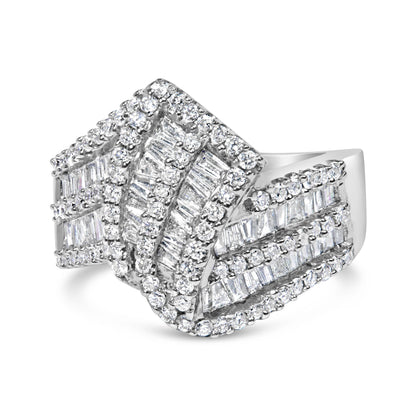 White metal ring with overlapping bands featuring round white gemstones in prong settings and baguette white gemstones in channel settings, shown in a front angled view.