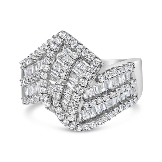 White metal ring with overlapping bands featuring round white gemstones in prong settings and baguette white gemstones in channel settings, shown in a front angled view.
