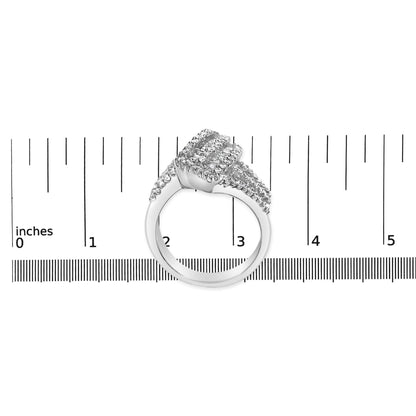 White metal ring with round and baguette shaped white gemstones, shown from the side on a ruler for size reference.