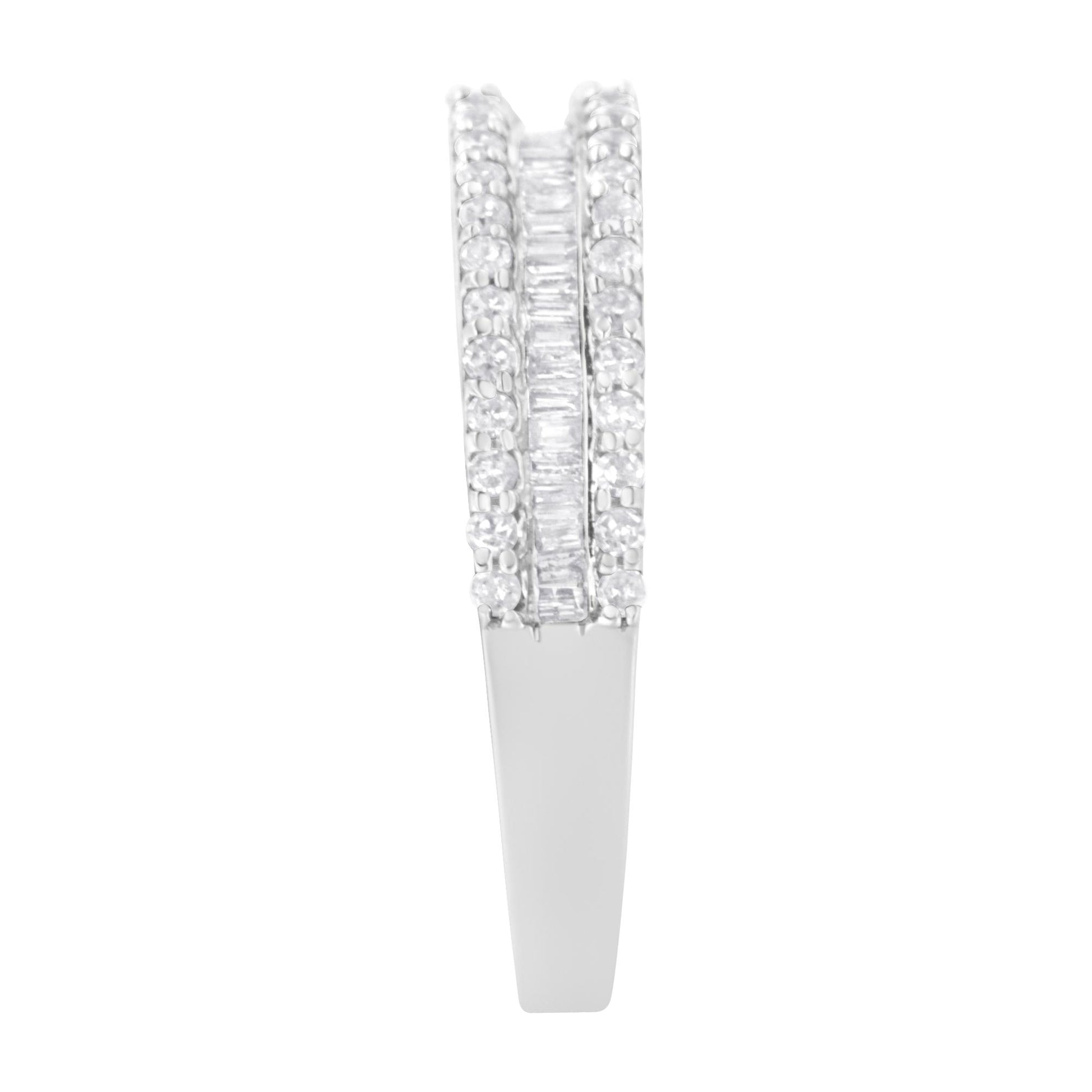 Close-up front view of a white metal ring featuring two outer rows of round white gemstones in prong settings and a middle row of baguette-shaped white gemstones in channel settings.