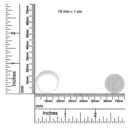 White metal ring with round and baguette white gemstones, shown from a side angle on a ruler and scale for size reference.