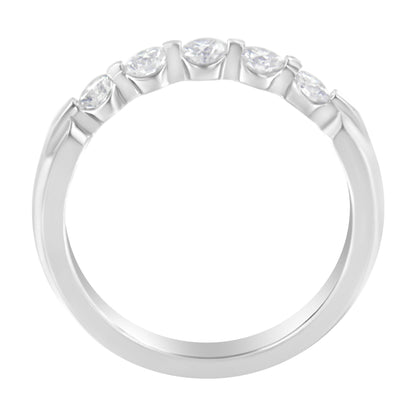 Top view of a white ring with five round white gemstones set in a channel setting.