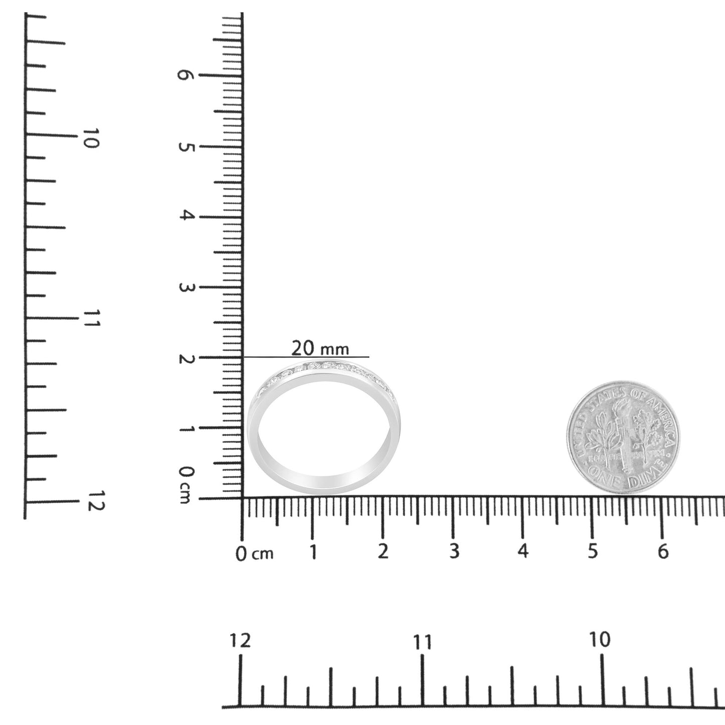 White metal ring with round white gemstones in a channel setting, shown from the front on a ruler for size reference.