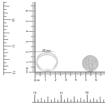 White metal ring with round white gemstones in a channel setting, shown from the front on a ruler for size reference.