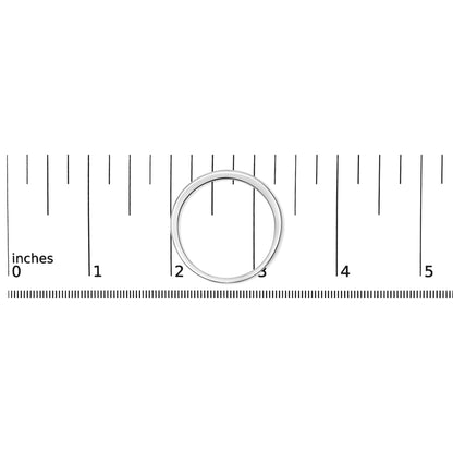 Top-down view of a white metal ring with a channel setting of small round white gemstones, placed on a ruler for size reference.