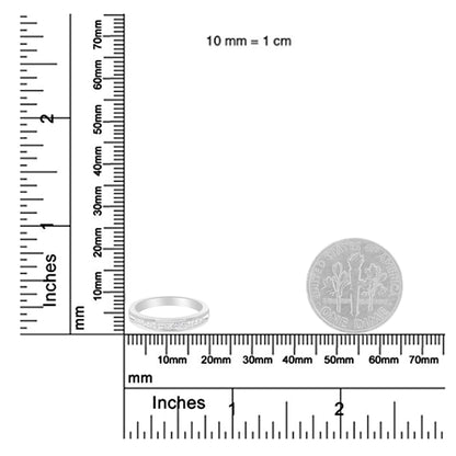 Close-up of white metal ring with channel-set princess-shaped white gemstones, shown on a ruler for size reference.