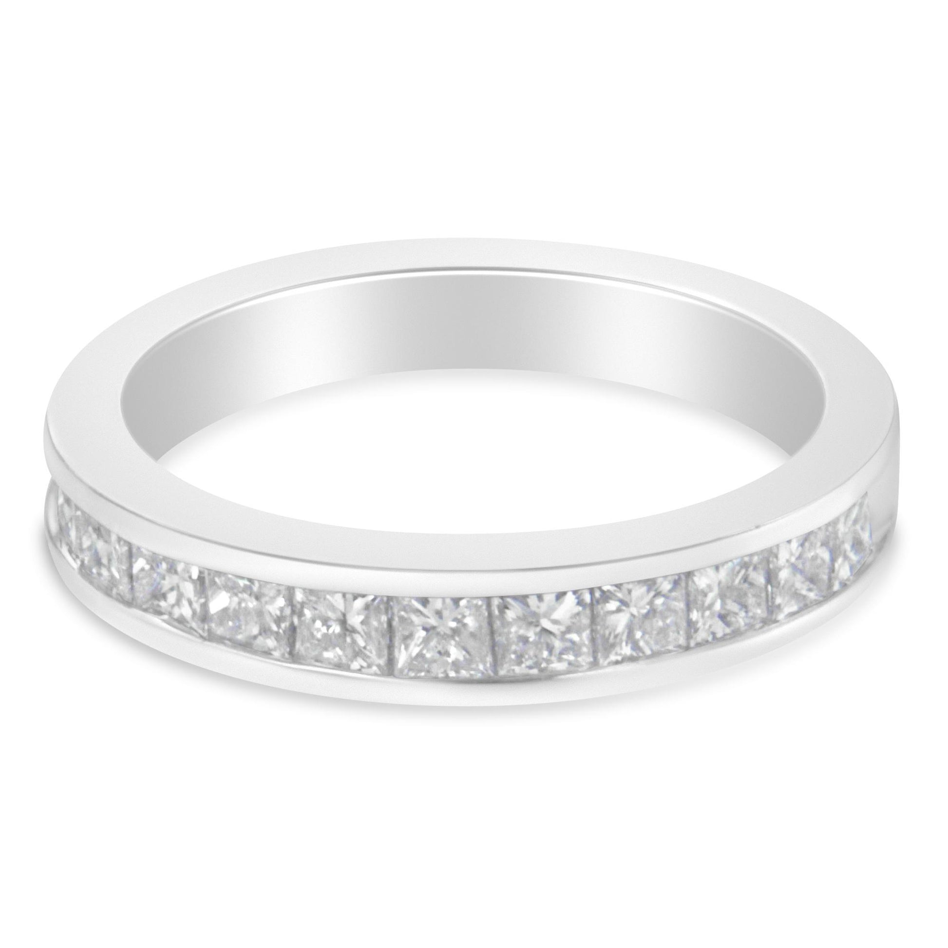 Close-up angled view of a white metal ring with a channel setting featuring a row of square white gemstones.