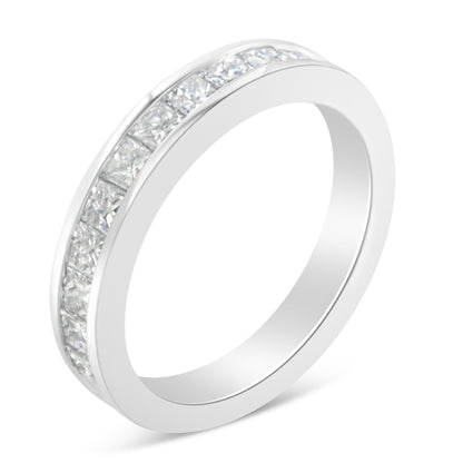 Close-up angled view of a white metal ring featuring a channel setting of princess-shaped white gemstones around the band.