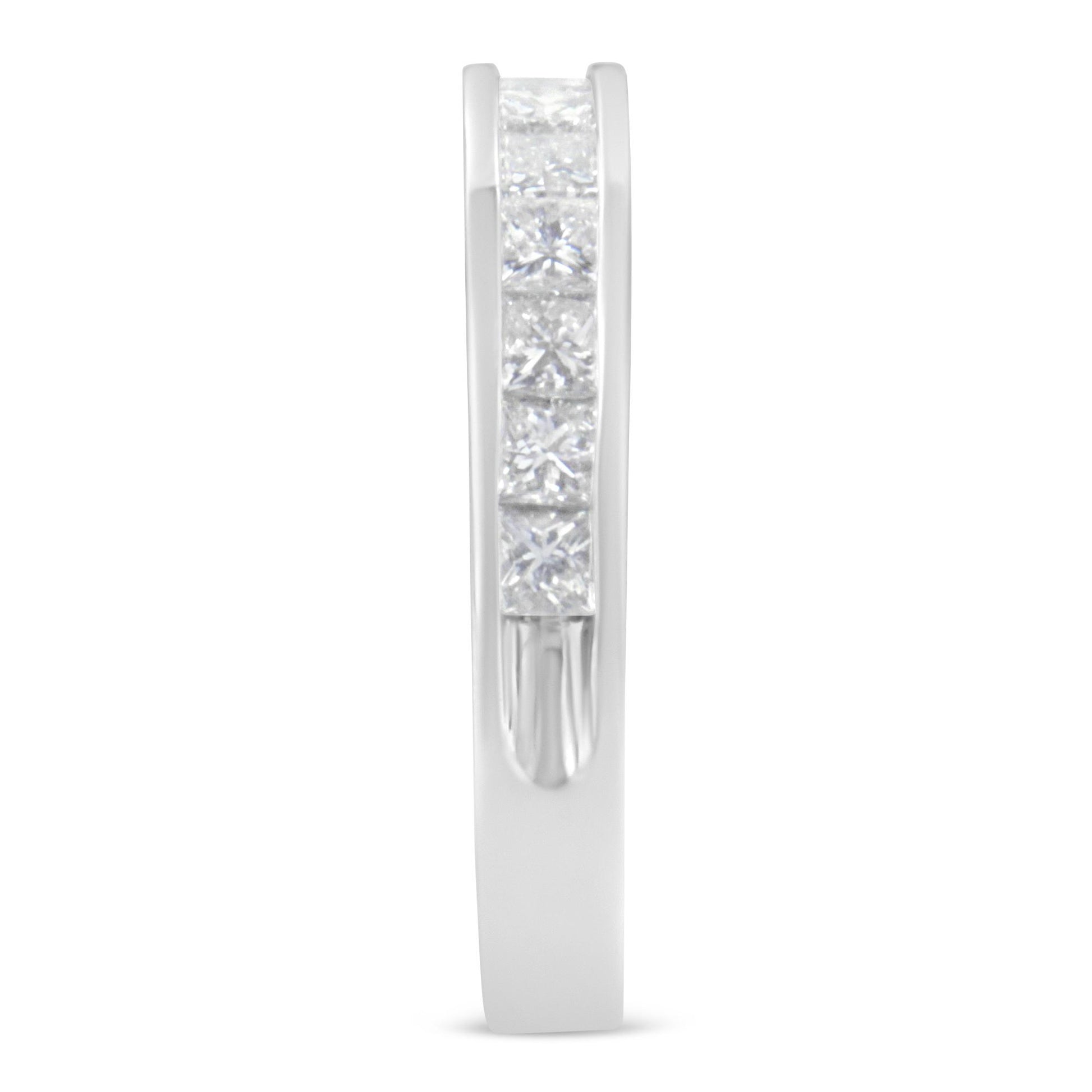 Side view of a white ring featuring a channel setting of square white gemstones.