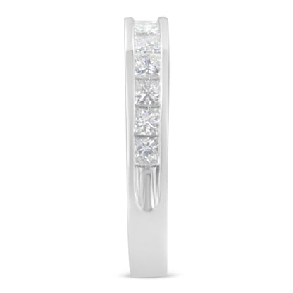 Side view of a white ring featuring a channel setting of square white gemstones.
