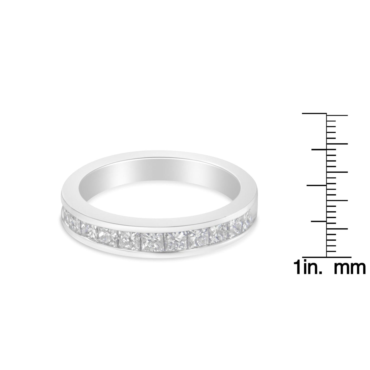 White metal ring with channel-set princess-shaped white gemstones viewed from a slight side angle, shown next to a ruler for size reference.