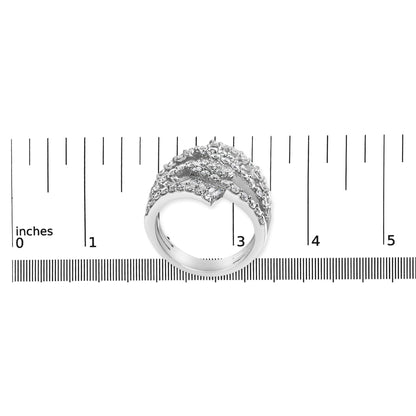White metal ring with rows of round and baguette-shaped white gemstones in prong and channel settings, shown from a top angle on a ruler scale.