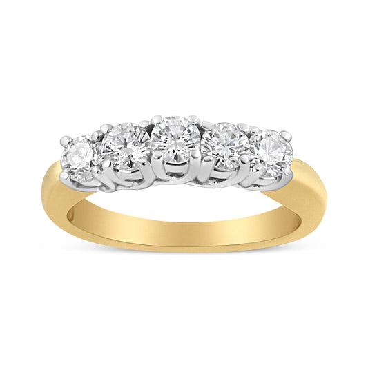 Front angle view of a yellow metal ring featuring a row of round white gemstones in prong settings.