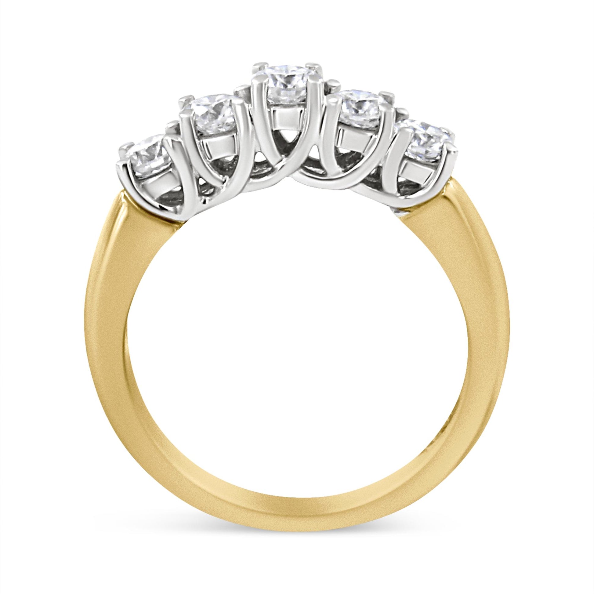 Yellow metal ring with five round white gemstones in prong setting, shown from a side angle.