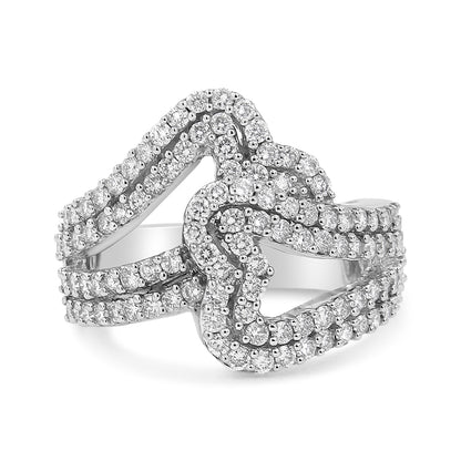 Close-up angled view of a white metal ring featuring multiple rows of round white gemstones in prong settings, forming an intricate intertwined design.