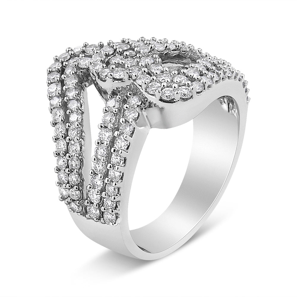 White metal ring with multiple rows of round white gemstones in prong settings, viewed at an angle.